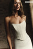A woman wears a structured corset-style bodice and a long wedding skirt_XS_