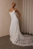 woman wearing a white lace backless dress with thin straps and delicate chain jewellery across her back_XS_
