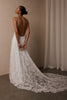 woman wearing a white lace backless dress with thin straps and delicate chain jewellery across her back_XS_