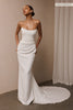 A woman wearing a strapless white wedding gown with a draped bodice and floor-length silhouette_xs_