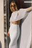 A woman models a sheer cape and a long wedding skirt_XS_