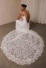 woman wearing a white lace backless dress with thin straps and delicate chain jewellery across her back_XS_