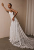 woman wearing a white lace backless dress with thin straps and delicate chain jewellery across her back_XS_