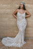 A woman in a lace wedding dress and headscarf.