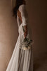 Side and back shot of the Pierlot gown with white bouquet