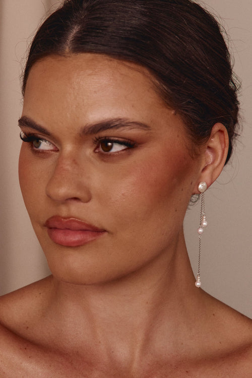 Close-up of a woman wearing pearl earrings