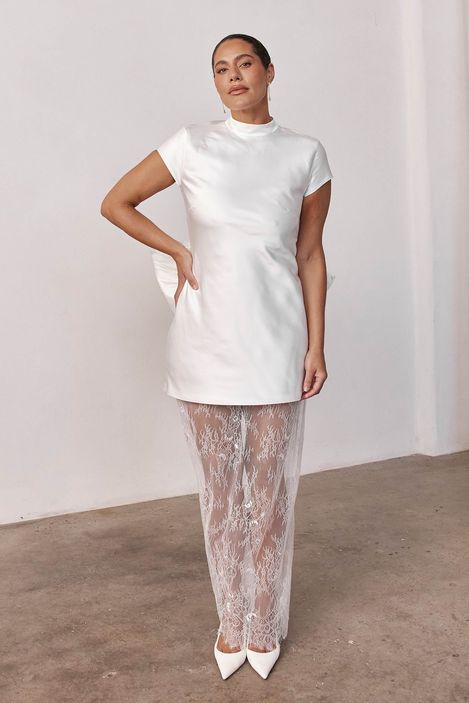 Woman wearing a short wedding dress and sheer skirt_L_