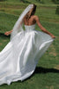 Woman wearing a satin A-line wedding dress_XS_