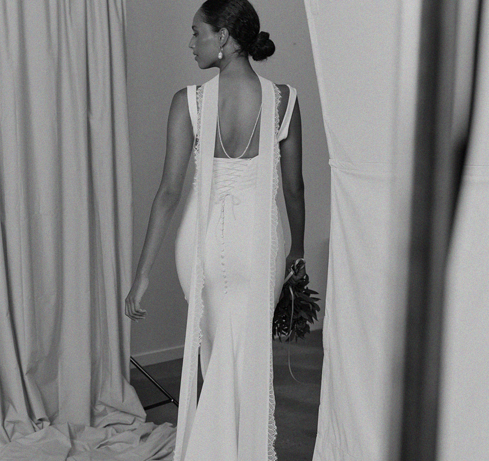 Woman wearing a bridal neck scarf and wedding dress.